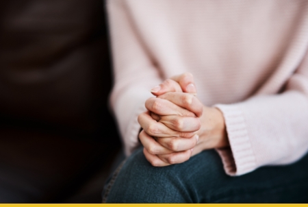 A close-up of a person's hands clasped together