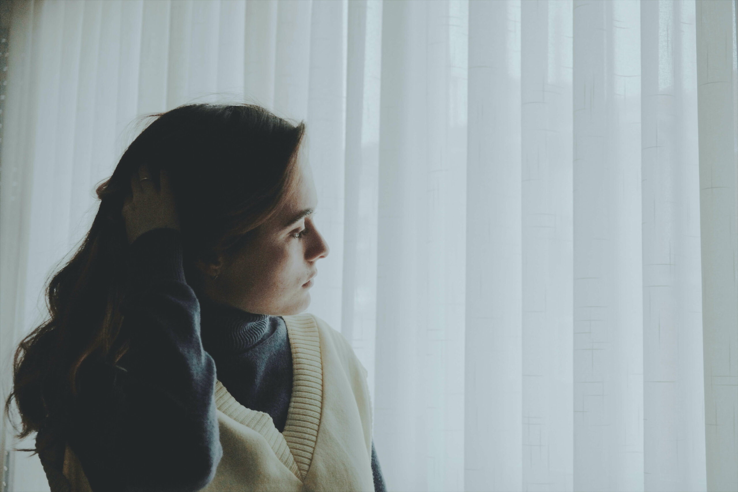 Forlorn woman looking out the window