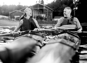 A man and woman enjoying a joyful kayak outing on a lake