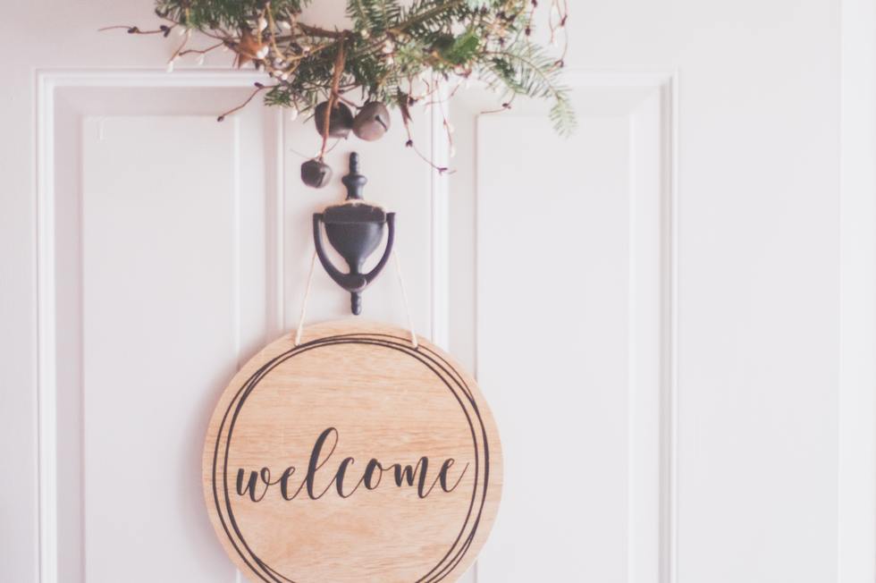 A welcome sign on the front door of a house